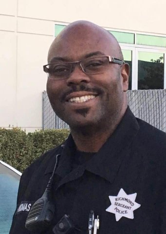 Smiling Black man in glasses and uniform that says Richmond Sergeant Police.