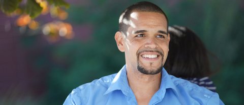 Melvin Willis, a light-skinned Black man with a goatee and light blue shirt.