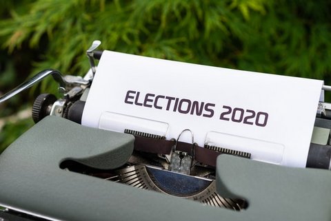A typewriter with the top of a piece of paper showing that says "ELECTIONS 2020."