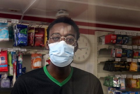Black 7 Eleven worker wearing glasses and face mask