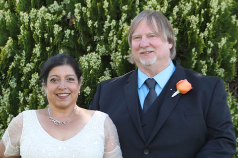 Indian woman in white wedding dress and white man in suit