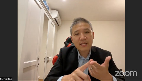 Asian man in a suit on Zoom