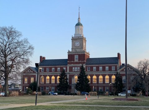 A red-brick university building with clock tower