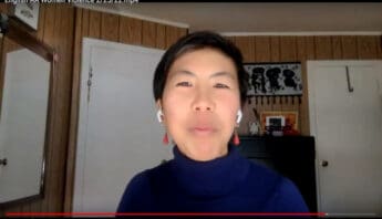 Chinese American woman wearing AirPods and earrings