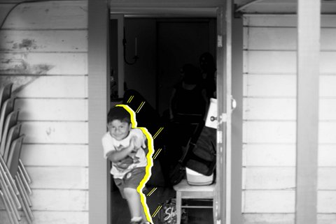 Black-and-white picture of a smiling little boy running out of his house. What would be his shadow is yellow with lines coming out of it