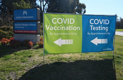 Signs for Kaiser Permanente Martinez Medical Offices and COVID-19 testing and vaccination