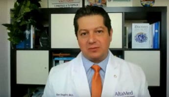 Latino doctor wearing white lab coat and orange tie