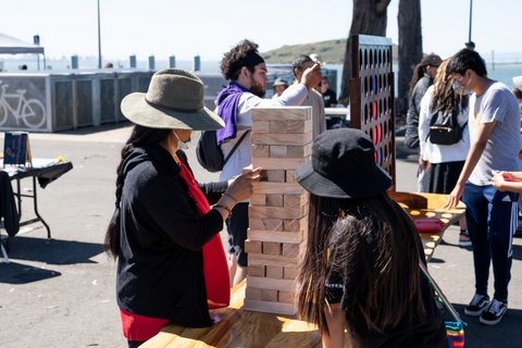 People playing oversized versions of Jenga and Connect Four