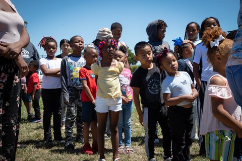 Black children standing in a line on grass