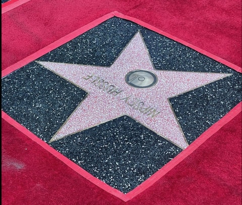 Nipsey Hussle's star on the Hollywood Walk of Fame, framed by red tape and a red carpet