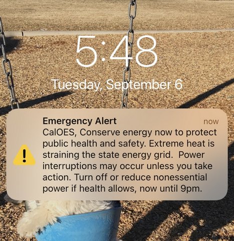 A screenshot of a text at 5:48 on Tuesday, September 6 that says, "Emergency Alert, CalOES, Conserve energy now to protect health and safety. Extreme heat is straining the state energy grid. Power interruptions may occur unless you take action. Turn off or reduce nonessential power if health allows, now until 9pm."