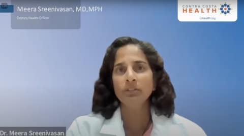 Head and shoulders shot of a South Asian woman in white lab coat. On-screen text shows she is Meera Sreenivasan, MD, MPH, of Contra Costa Health
