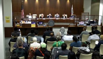 Richmond city council meeting with several people in the audience