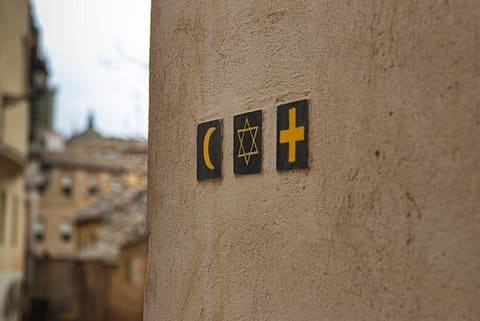 Symbols on a wall for Islam, Judaism and Christianity