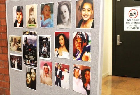 Several photos of the same Latina teen pinned to a board. A door in the background has a sign that says no food or drinks in the theater.