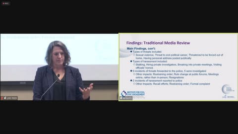 Side by side shots of a white person at a microphone and a text slide that reads: Findings traditional media review. Main findings continued. Type of threats included sexual violence, threat to end political career, threatened to be forced out of home, having personal address posted publicly. Types of harassment included stalking, hiring private investigators, breaking into private meetings, visiting officials' homes. Nine incidents of threats forwarded to police, five were investigated. Other impacts: restraining order, rule change at public forums, meetings online rather than in person, resignations. Two incidents of harassment reported to police. Other impacts: recall efforts, restraining order, formal complaint.