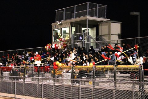 Stands with fans at a high school soccer game