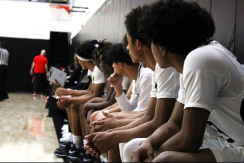 High school basketball players sitting on the bench