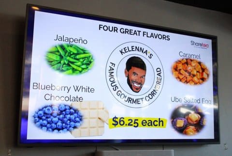 Screen with text that reads four great flavors jalapeño, caramel, blueberry white chocolate, ube salted egg, Kelenna's famous gourmet cornbread $6.25 each, along with an illustration of a black man's face and pictures of jalapeños, blueberries, caramels and a dish made with ube.