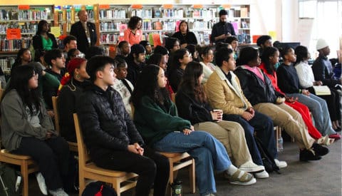 rows of high school students sitting in their school library