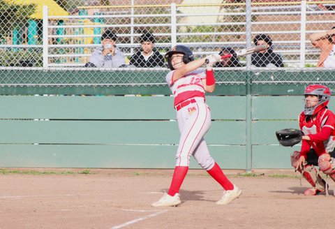softball player following through on her swing