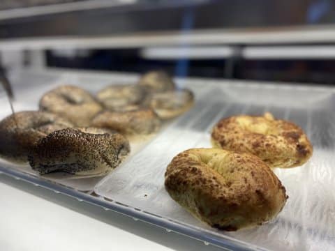 Bagels on trays in a glass case