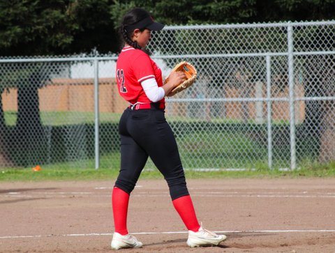 Softball player holding the ball in her glove