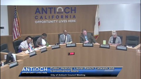 text: public hearing laurel ranch canyon car wash and convenience store city of antioch council meeting. the council members are two black women, a black man, white man and white woman