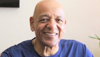 a smiling bald older black man looking at the camera