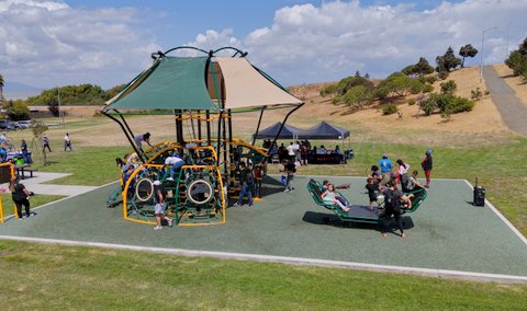 several kids playing on a new playground structure