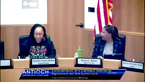 two black women with nameplates that identify them as tamisha torres walker council member and monica e wilson mayor pro tem. text reads antioch opportunity lives here consideration of a cannabis operating agreement for ant green LLC. city of antioch council meeting