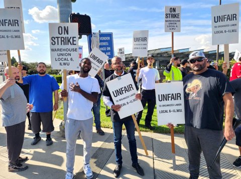 men with picket signs that either read "on strike warehouse union local 6 ILWU" or "unfair to organized labor local 6 ILWU"