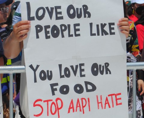 sign that reads love our people like you love our food stop AAPI hate