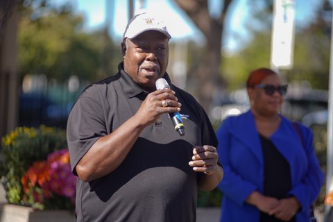 black man speaking into a microphone