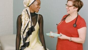 Updated Covid Vaccines Are Here and They’re Effective doctor-with-vaccine-tray-talking-to-a-young-woman_48545976811_o