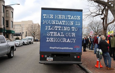 back of a box truck with message that reads "the heritage foundation is plotting to steal our democracy"and a website stop the coup 2025 dot org