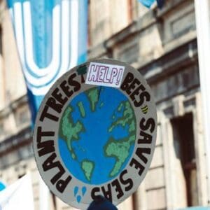 drawing of earth encircled with the words plant trees help bees save seas