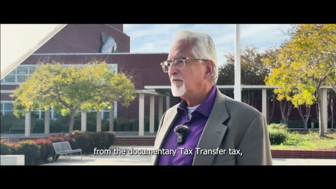 latino man with white hair and goatee standing outside