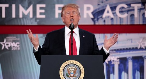 donald trump at a lectern with the president of the united states seal