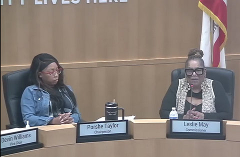 two black women in meeting in antioch city council chambers with nameplates identifying them as porshe taylor chairperson and leslie may commissioner