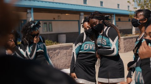 black cheerleaders wearing black masks for covid protection