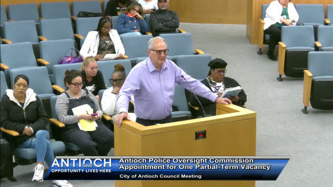 older white man at lectern. black and white people seated behind him. text that reads antioch police oversight commission appointment for one partial term vacancy. city of antioch council meeting