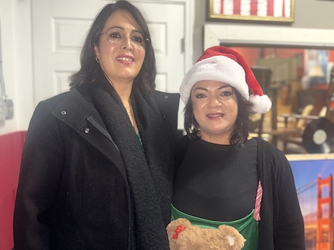 two latina women standing side by side. the one on the right is the same woman as the one in the first photo of this story