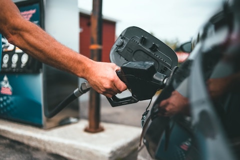 closeup of person pumping gas